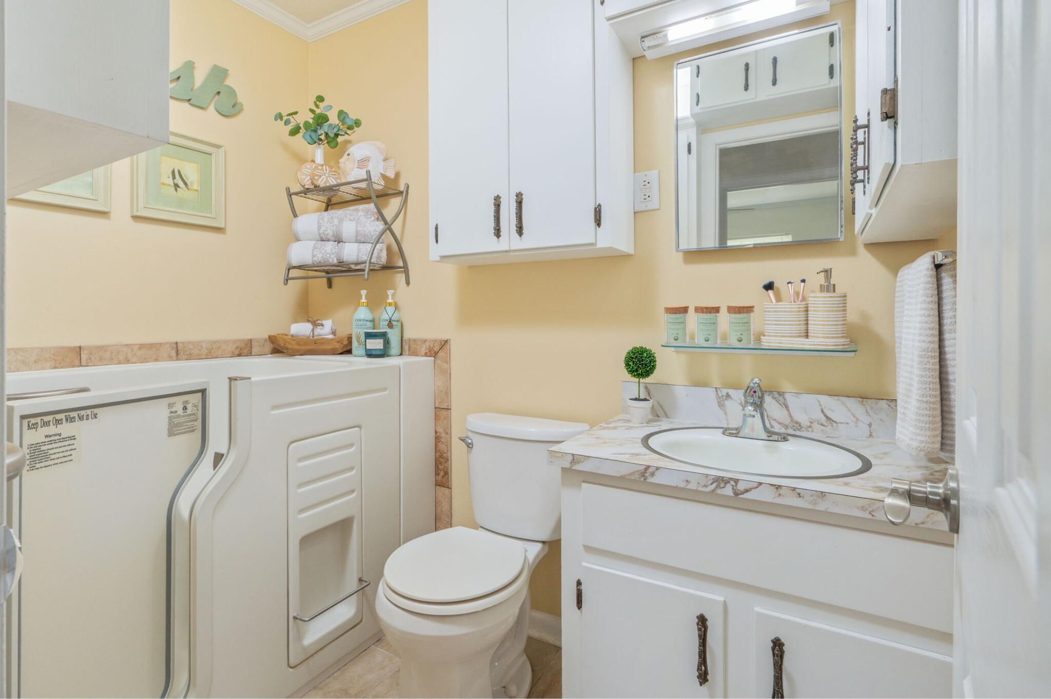 501 Jones Road Crestview, FL 32536 - Photo 25 of 32 a bathroom with a granite countertop toilet sink and mirror