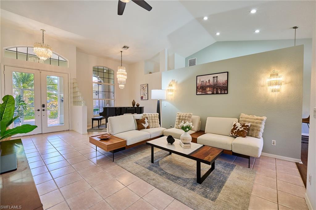 186 Muirfield Circle Naples, FL 34113 - Photo 6 of 36 a living room with furniture and wooden floor