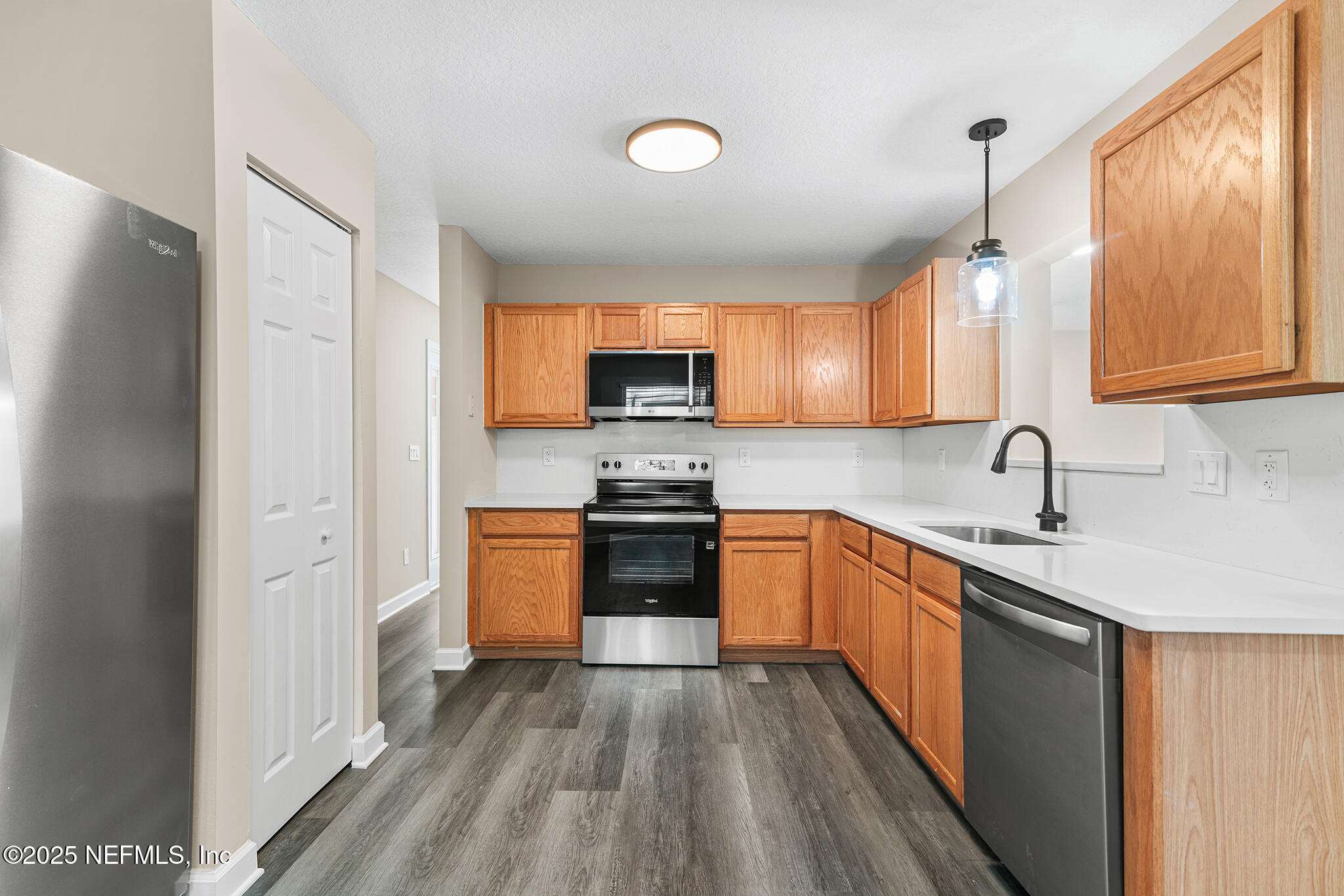 452 Dutton Island Road West Atlantic Beach, FL 32233 - Photo 14 of 25 a kitchen with stainless steel appliances granite countertop a sink stove and refrigerator