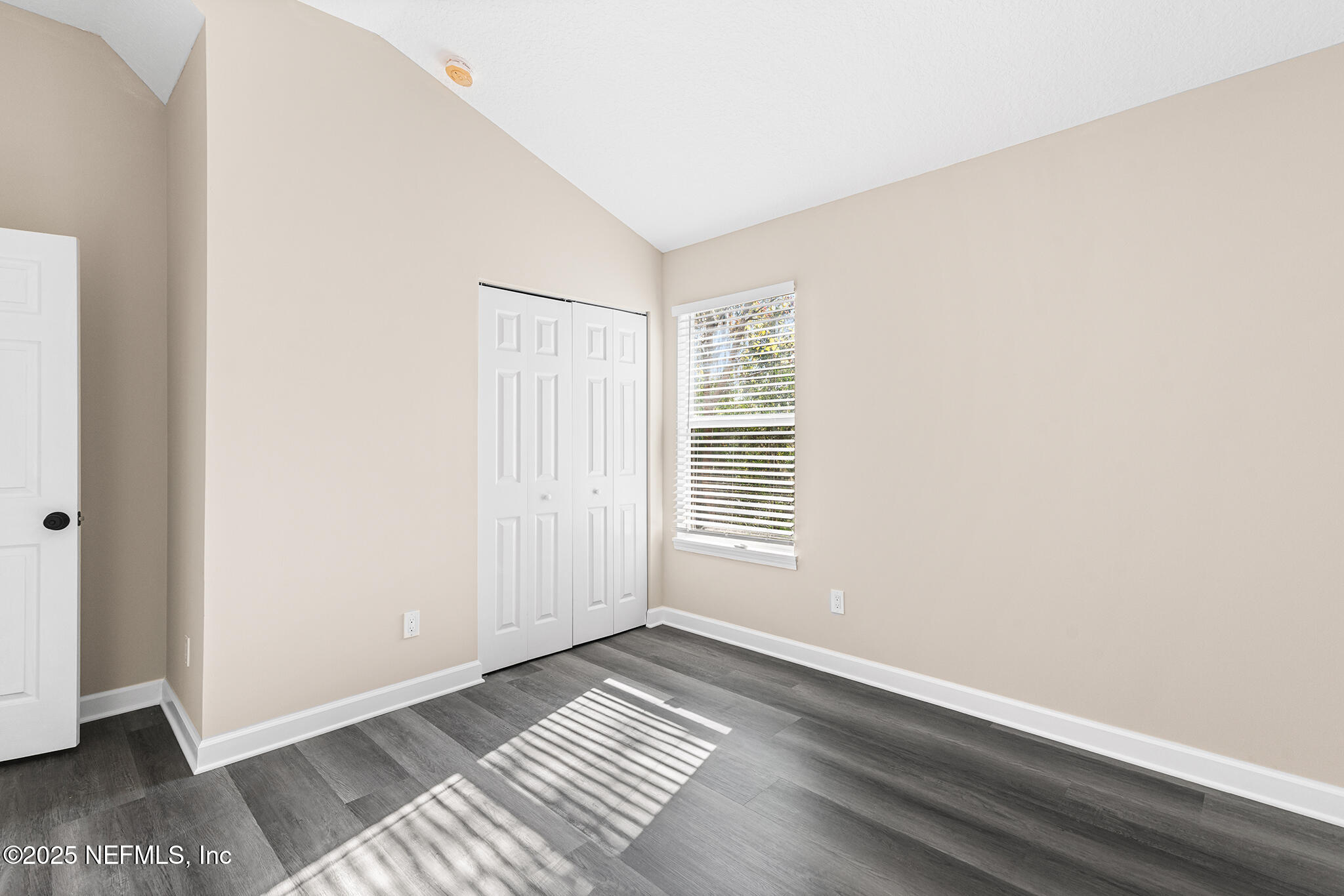 452 Dutton Island Road West Atlantic Beach, FL 32233 - Photo 19 of 25 a view of an empty room with wooden floor and a window