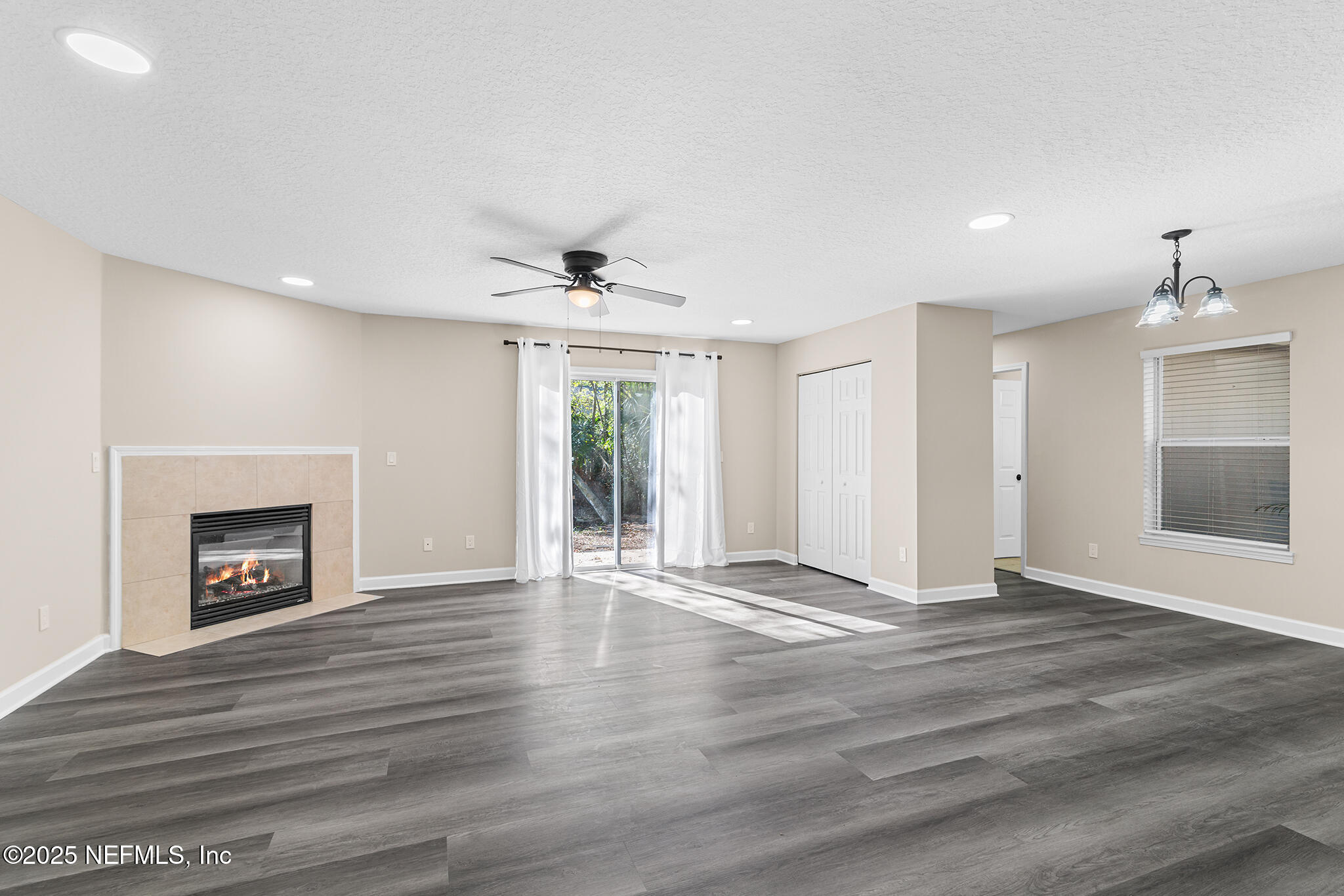 452 Dutton Island Road West Atlantic Beach, FL 32233 - Photo 2 of 25 a view of an empty room with a fireplace and a window