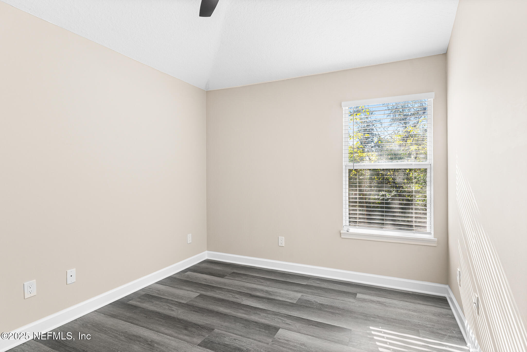 452 Dutton Island Road West Atlantic Beach, FL 32233 - Photo 21 of 25 a view of an empty room with wooden floor and a window