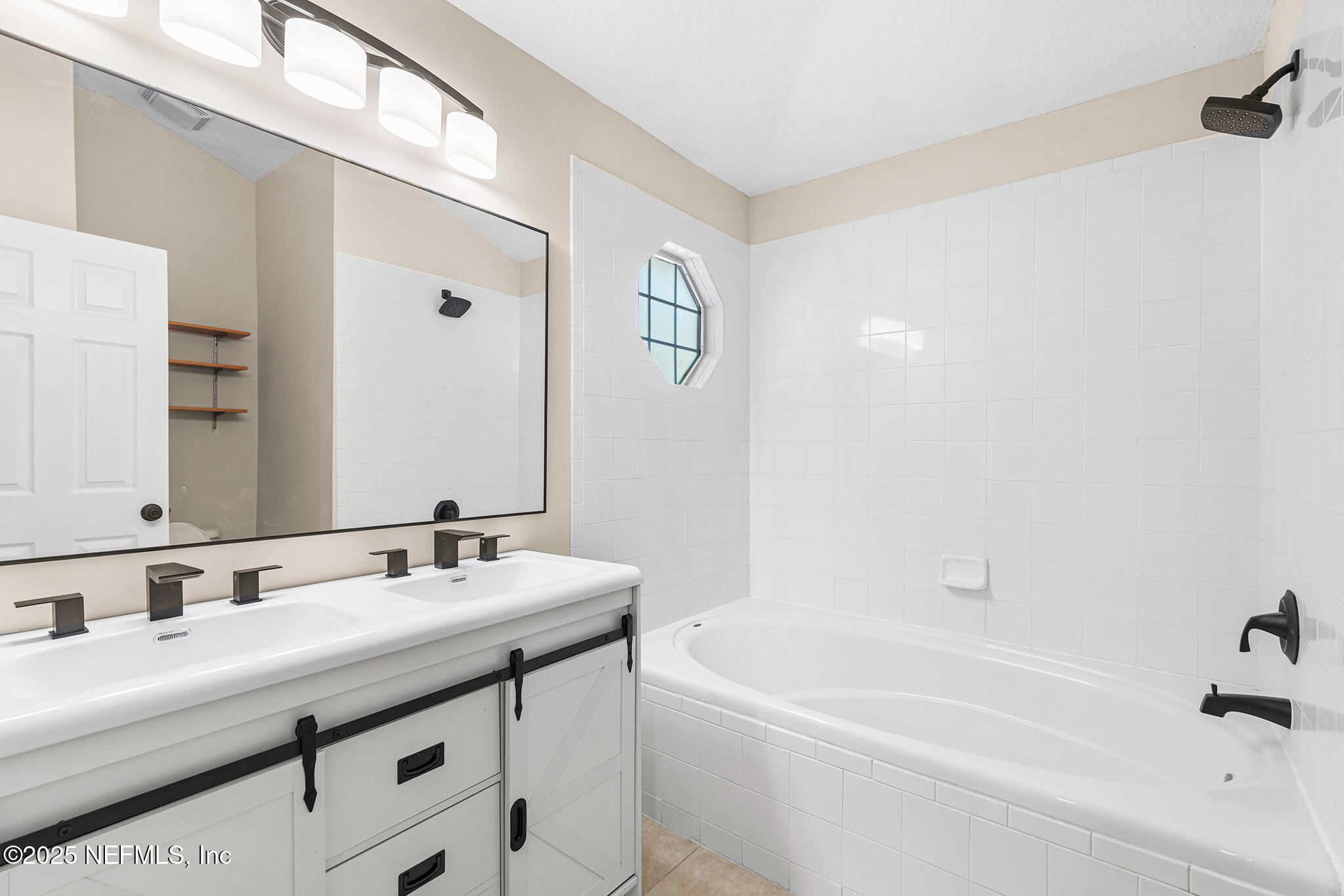 452 Dutton Island Road West Atlantic Beach, FL 32233 - Photo 8 of 25 a bathroom with a tub a sink and mirror