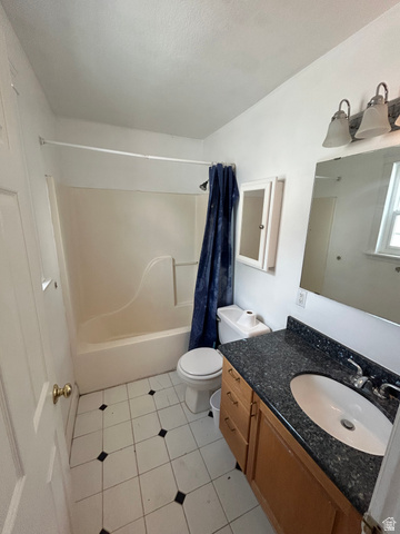 432 Spring Lane Logan, UT 84341 - Photo 18 of 22 Full bathroom with vanity, shower / bath combination with curtain, and light tile patterned flooring