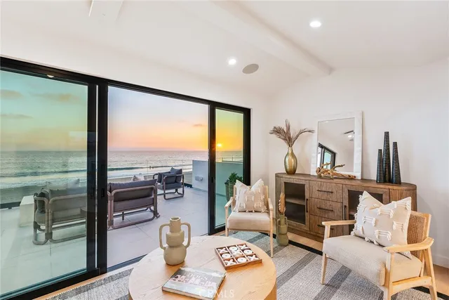a dining room with furniture and large windows