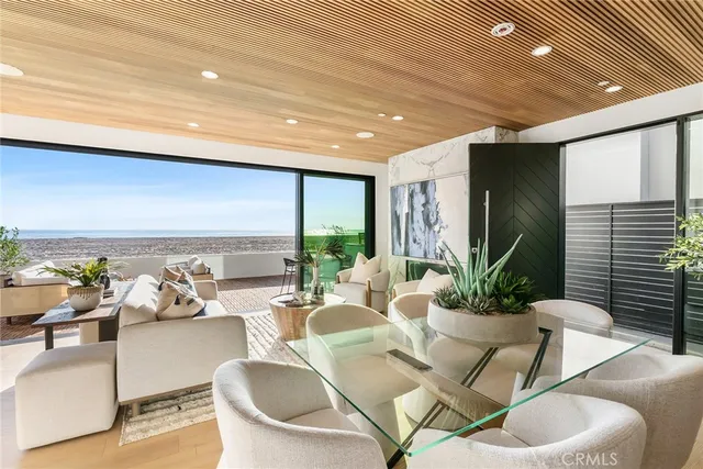 a living room with furniture and potted plants