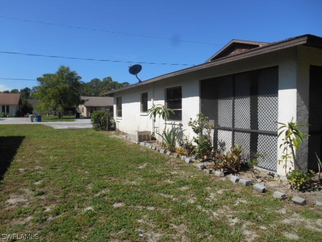 7441-43 Garry Road Fort Myers, FL 33967 - Photo 15 of 15 a front view of a house with garden