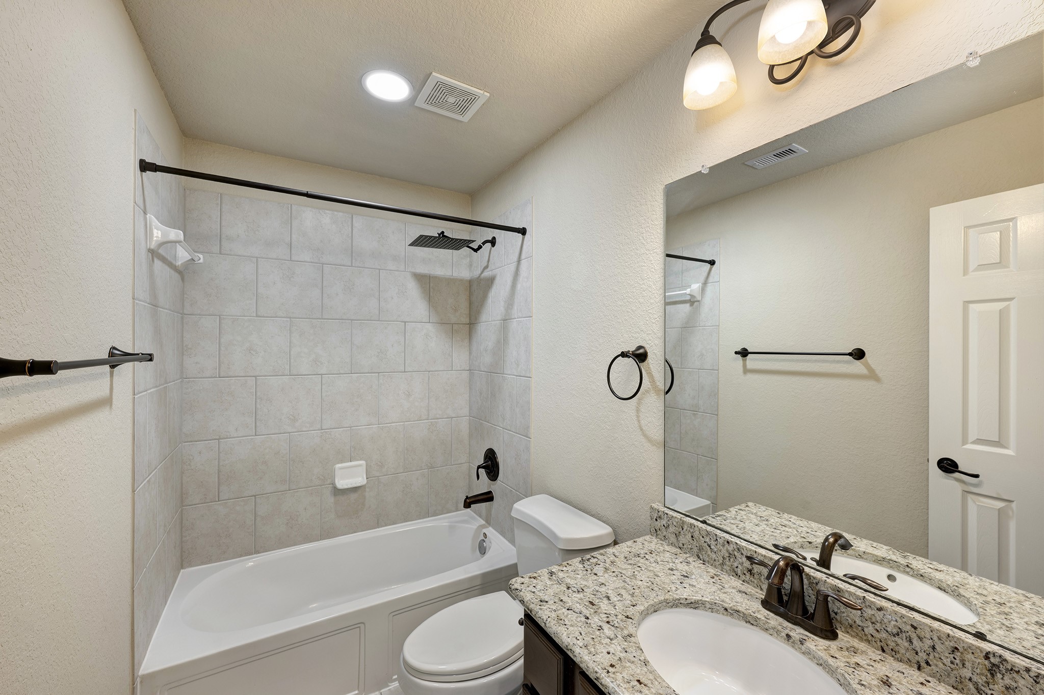 11 Red Wagon Drive Spring, TX 77389 - Photo 25 of 32 The first of two full baths located upstairs. Each has a tub with shower and granite countertops with bronze fixtures.