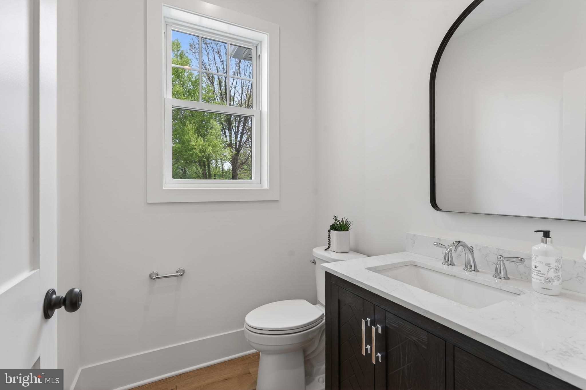 13 Rhoads Lane Media, PA 19063 - Photo 34 of 67 a bathroom with a granite countertop toilet sink and mirror