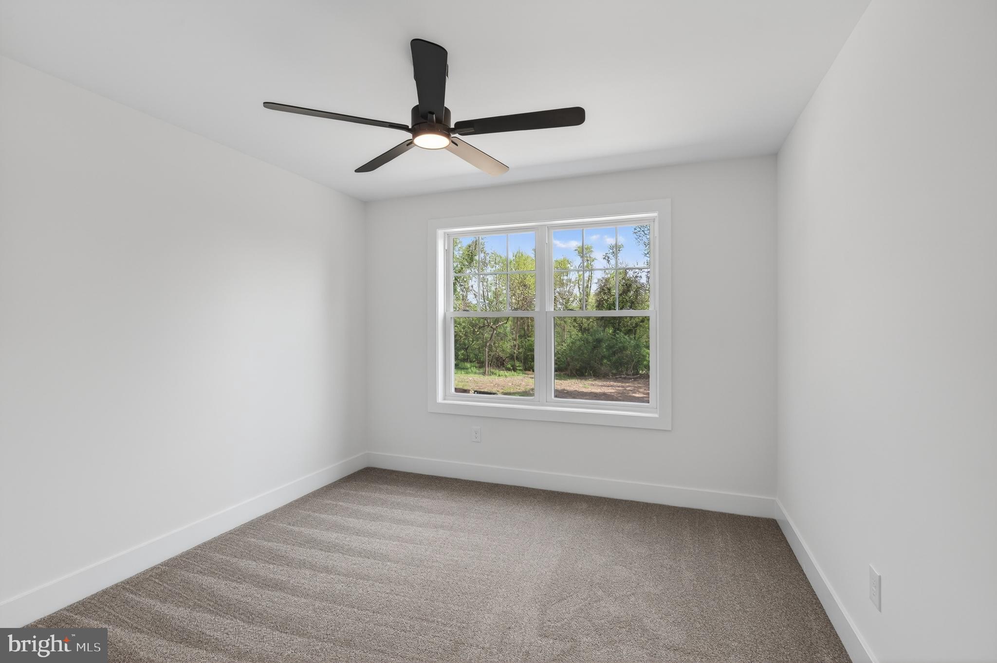 13 Rhoads Lane Media, PA 19063 - Photo 52 of 67 an empty room with a window and a ceiling fan