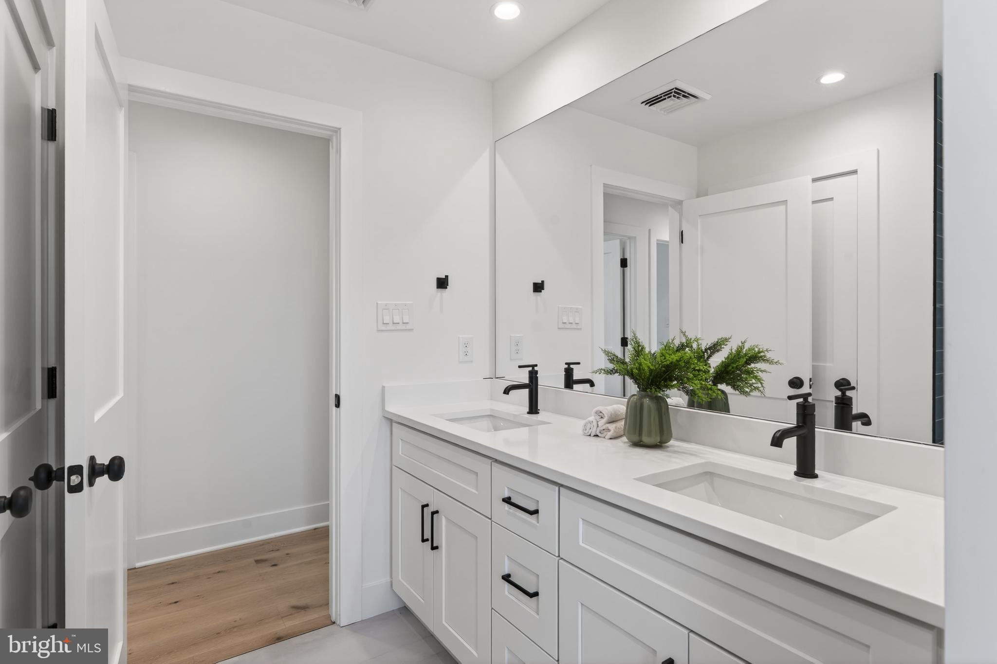 13 Rhoads Lane Media, PA 19063 - Photo 55 of 67 a bathroom with a granite countertop sink a mirror and a potted plant