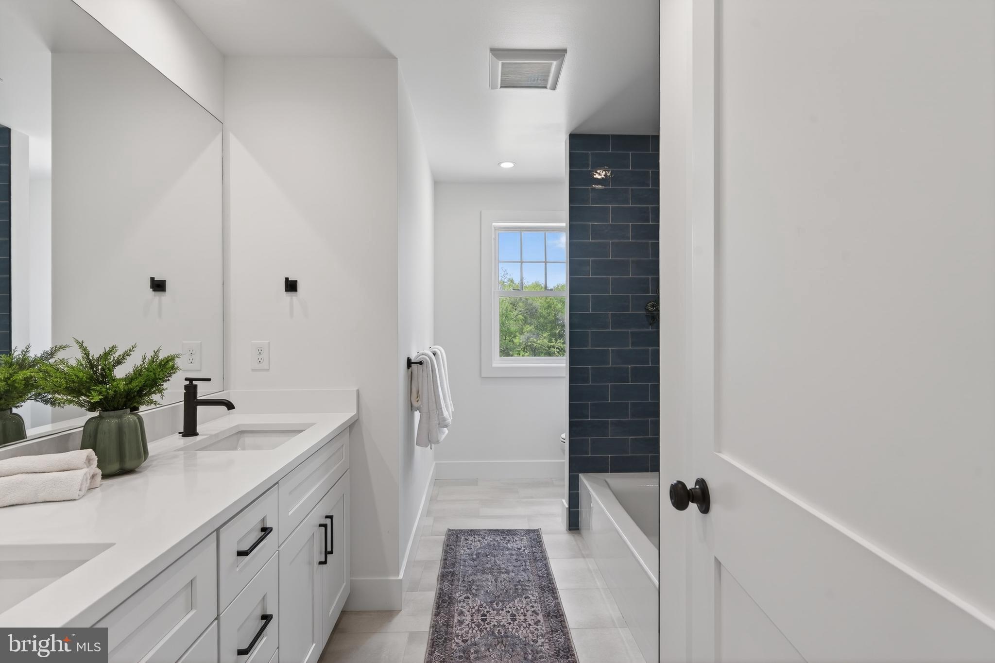 13 Rhoads Lane Media, PA 19063 - Photo 56 of 67 a bathroom with a sink a potted plant and a shower
