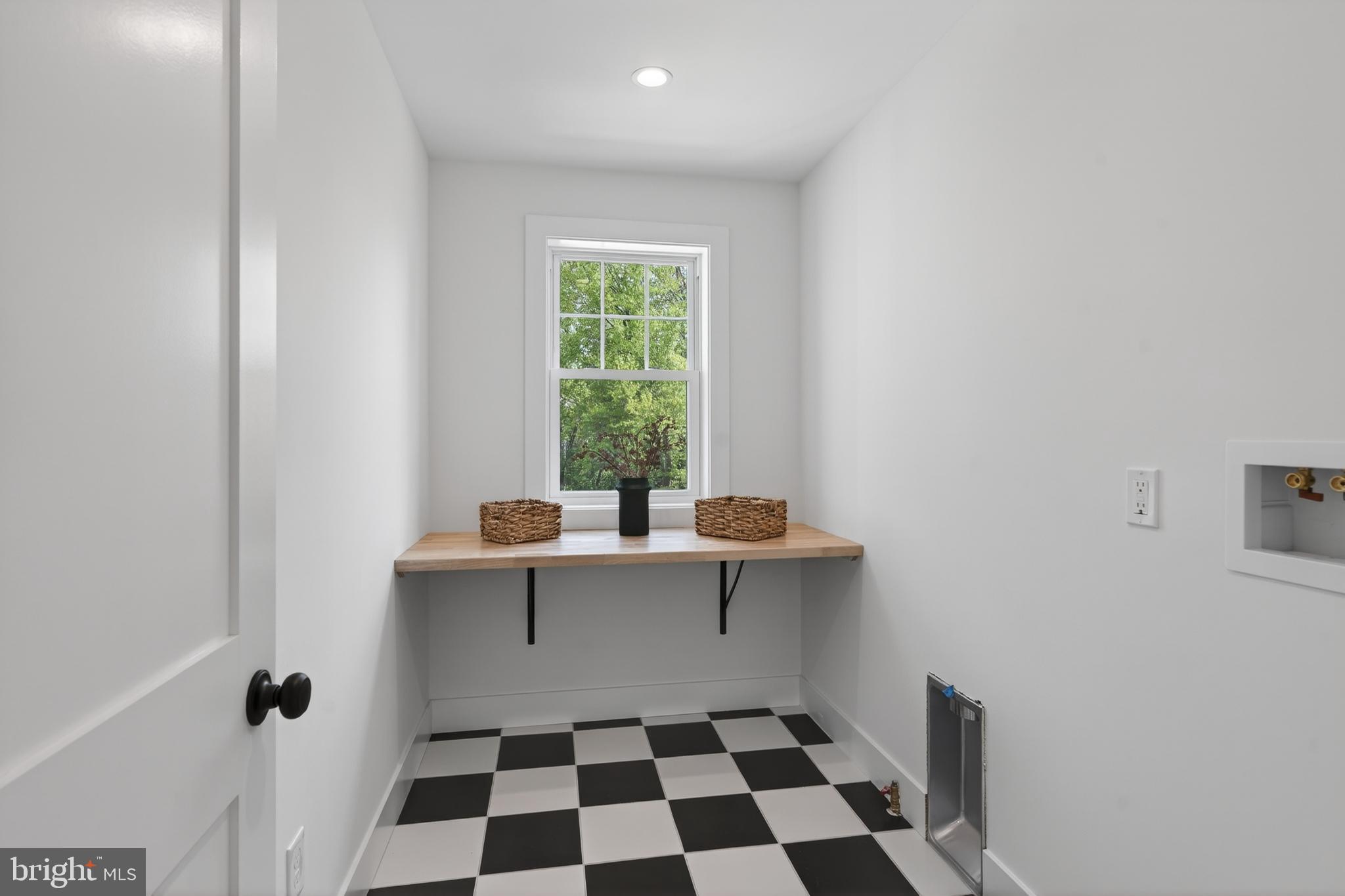 13 Rhoads Lane Media, PA 19063 - Photo 57 of 67 a room with a black white checkered floor with a gaming machine and a rug