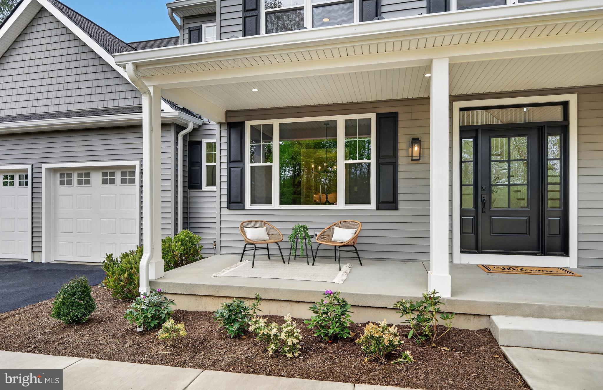 13 Rhoads Lane Media, PA 19063 - Photo 6 of 67 a front view of a building with outdoor seating and a potted plant
