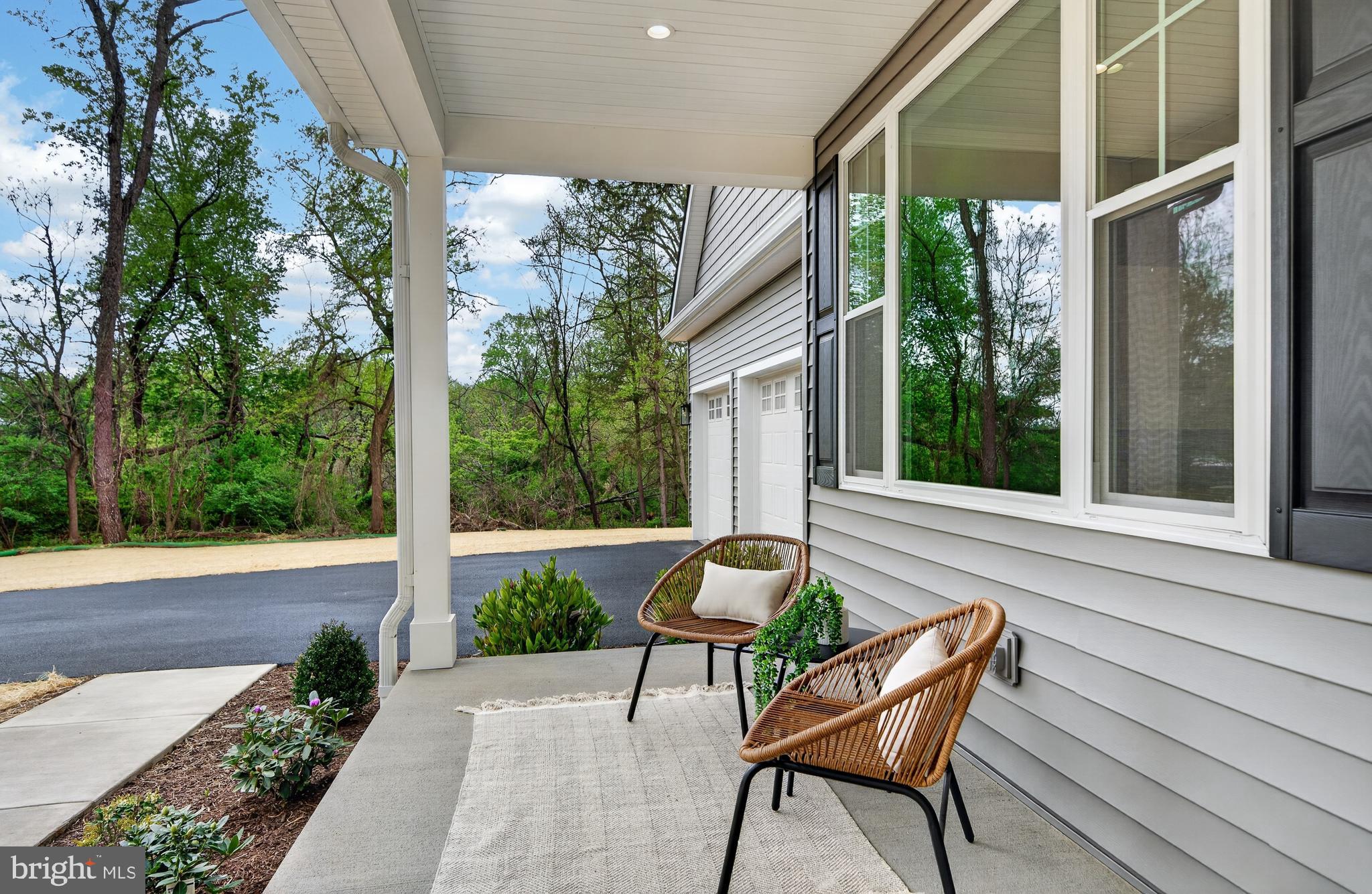 13 Rhoads Lane Media, PA 19063 - Photo 7 of 67 a view of a chair and tables in the patio with a backyard