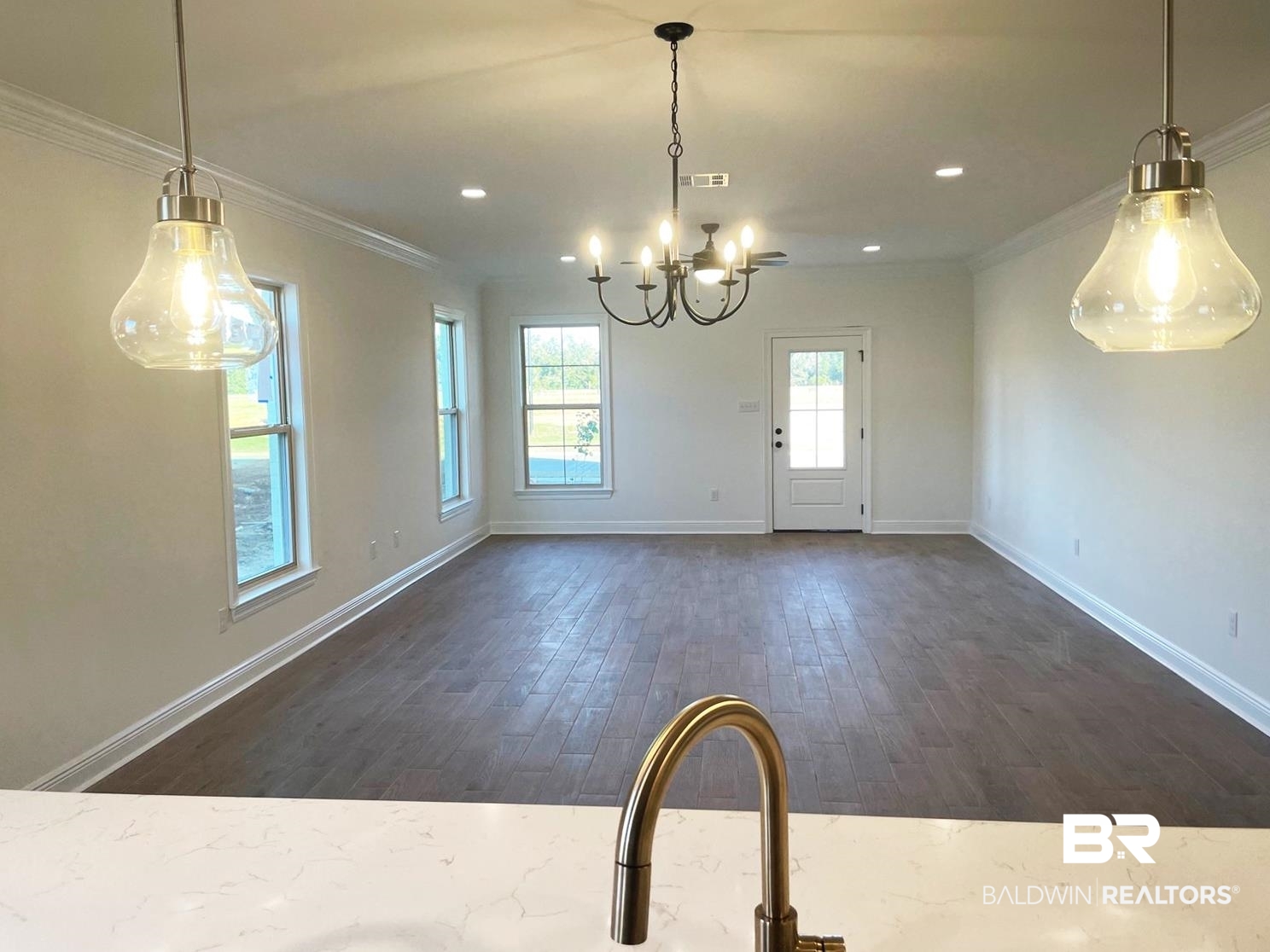1363 Fenton Circle Foley, AL 36535 - Photo 5 of 20 Unfurnished dining area with a chandelier, ornamental molding, and dark wood-type flooring