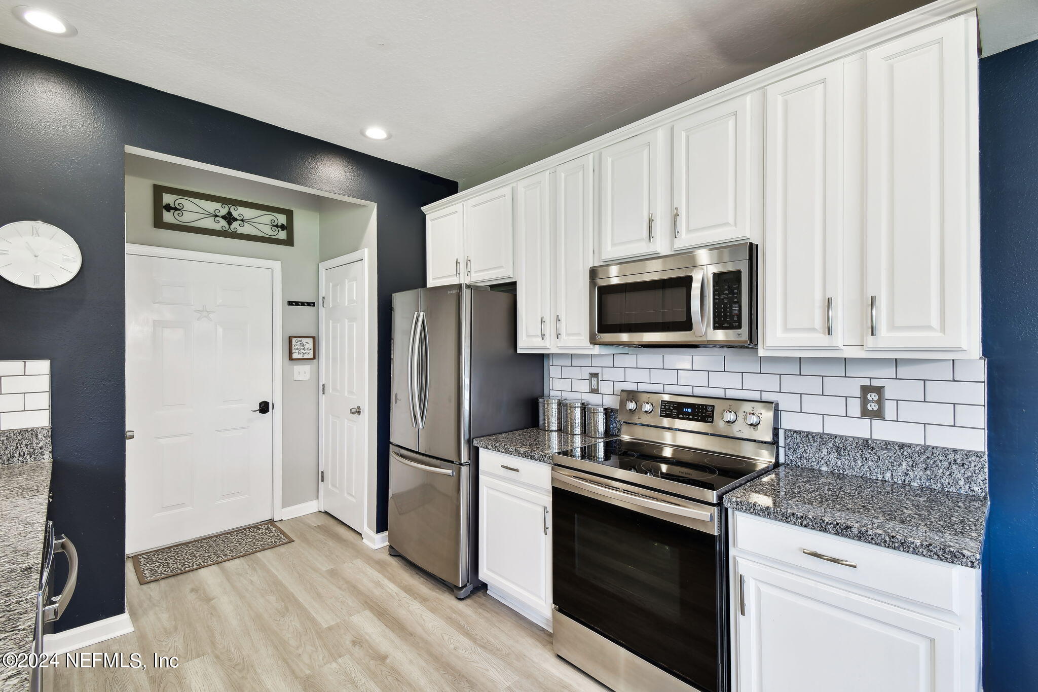 7473 Devondale Way Jacksonville, FL 32256 - Photo 19 of 68 a kitchen with stainless steel appliances granite countertop a refrigerator stove and microwave