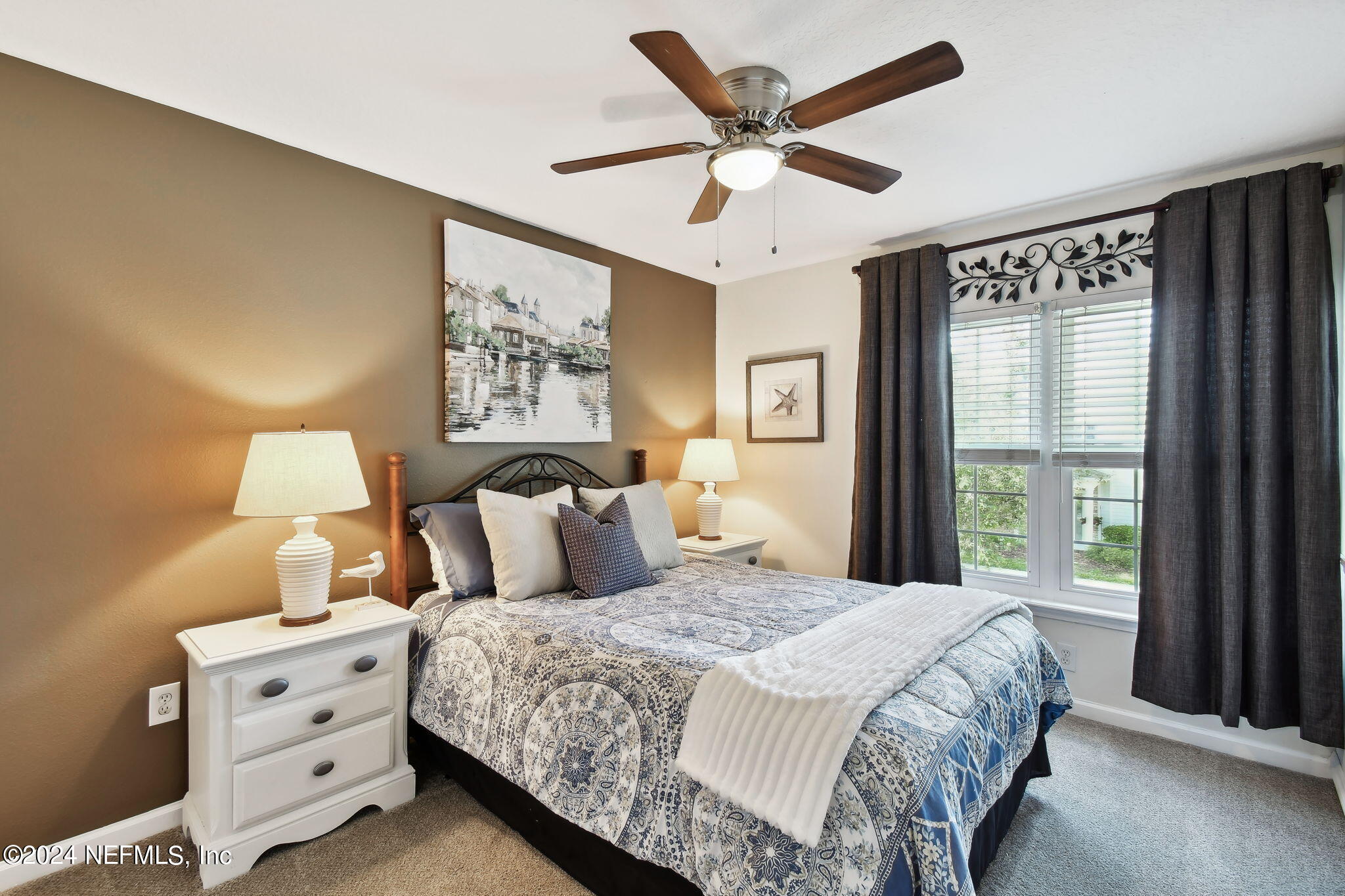 7473 Devondale Way Jacksonville, FL 32256 - Photo 25 of 68 a bedroom with a large bed and a large window