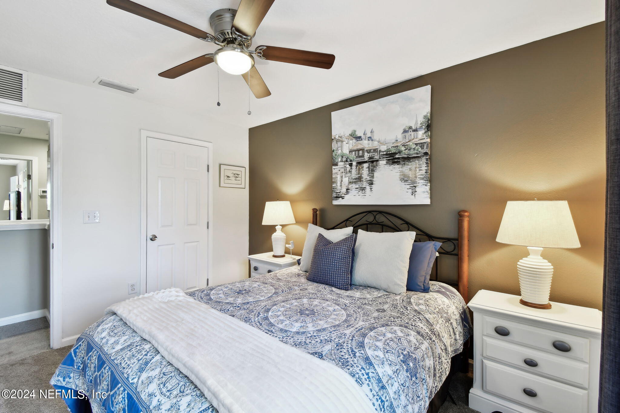 7473 Devondale Way Jacksonville, FL 32256 - Photo 26 of 68 a bedroom with a bed and a painting on the wall