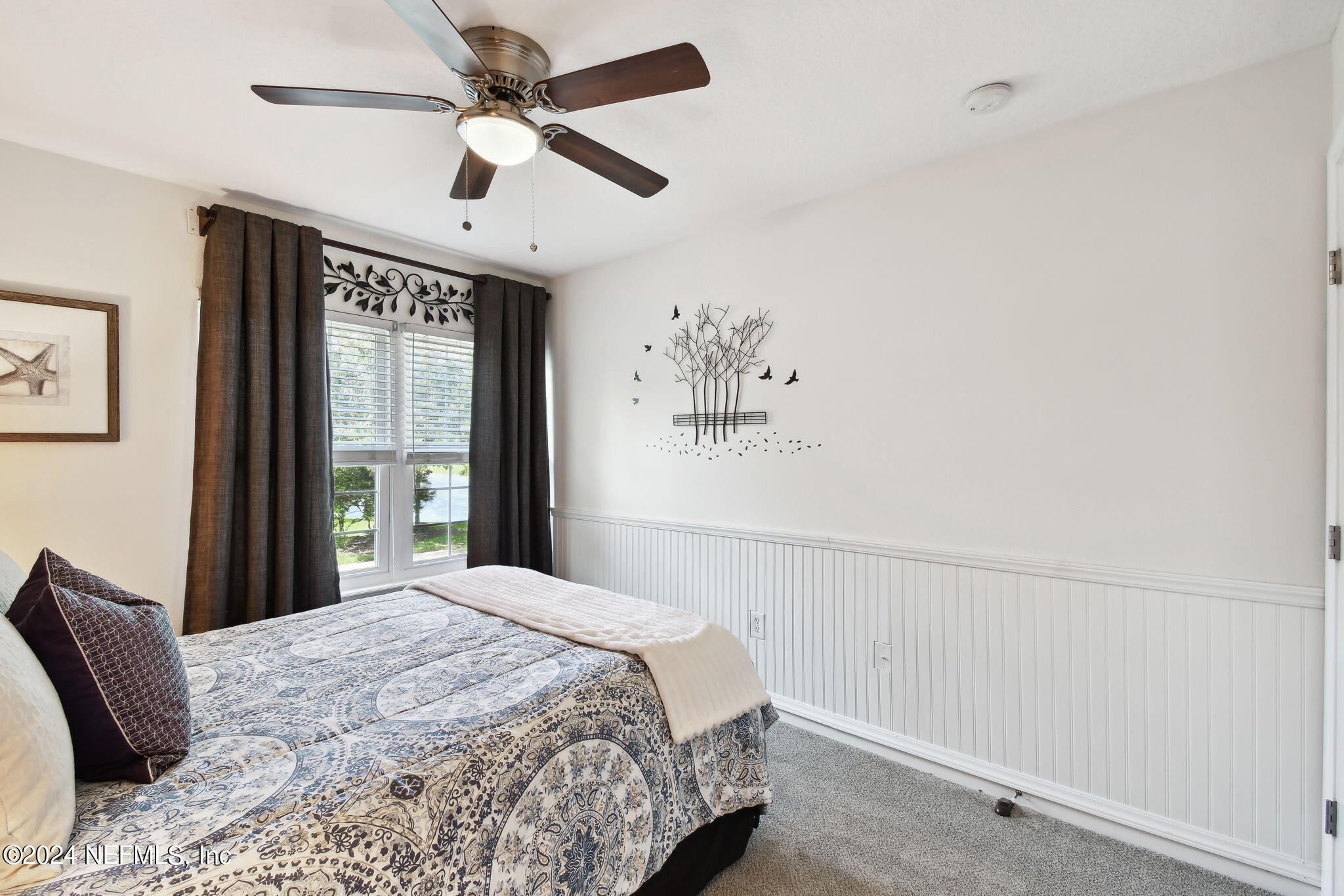 7473 Devondale Way Jacksonville, FL 32256 - Photo 27 of 68 a bedroom with a large bed and a window