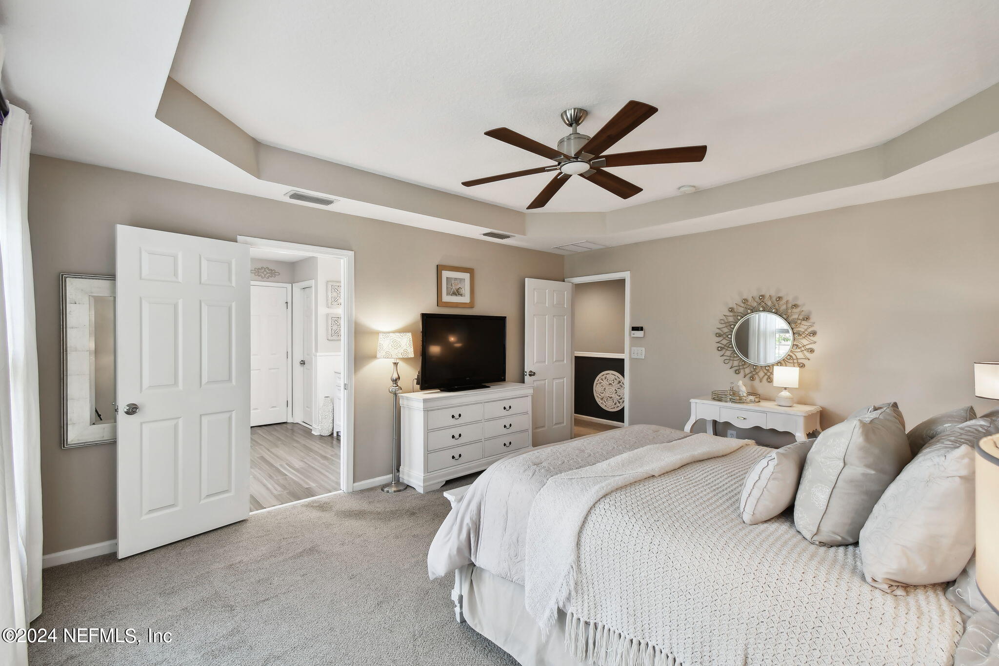 7473 Devondale Way Jacksonville, FL 32256 - Photo 33 of 68 a bedroom with a bed and a flat tv screen
