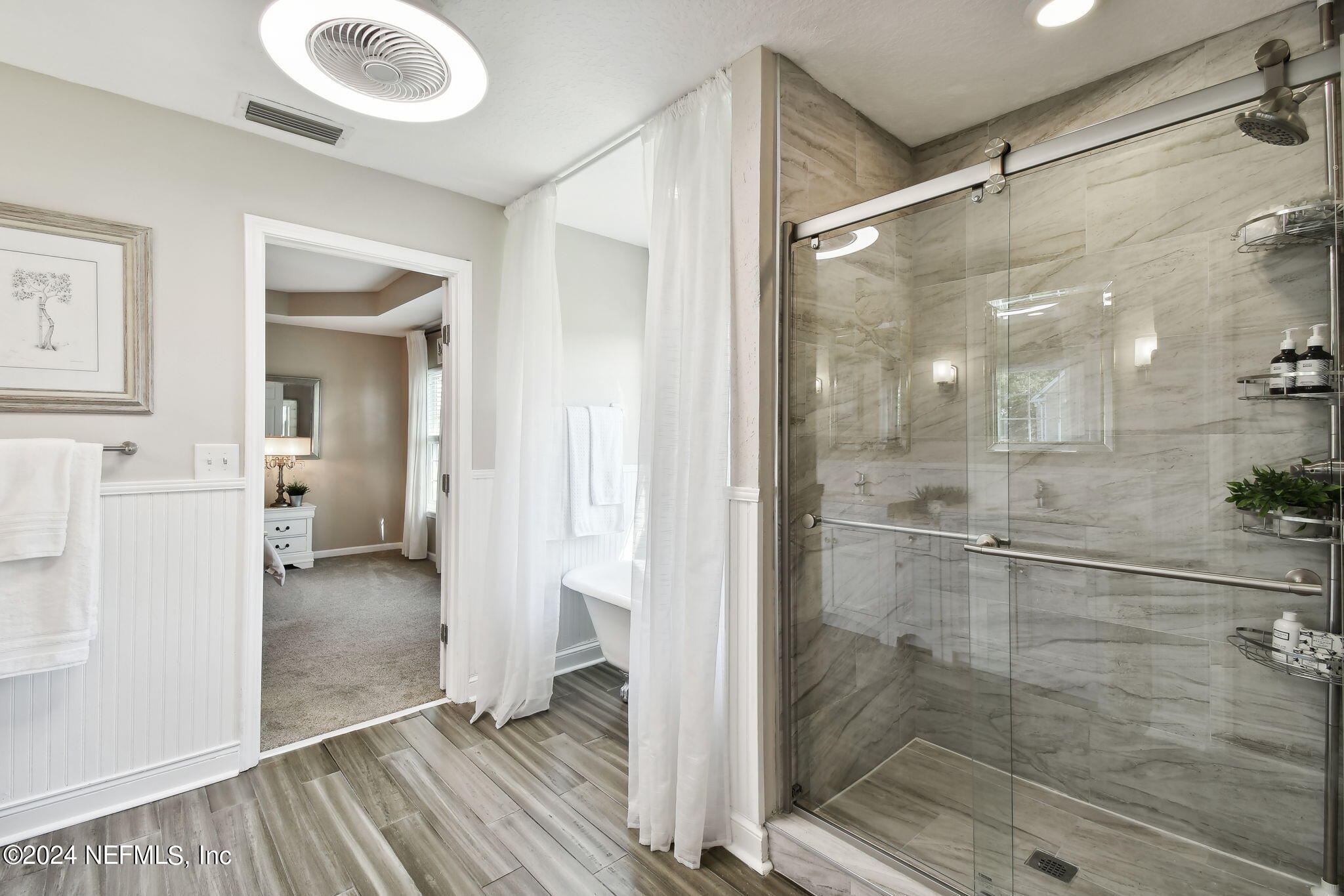 7473 Devondale Way Jacksonville, FL 32256 - Photo 38 of 68 a bathroom with a glass shower door