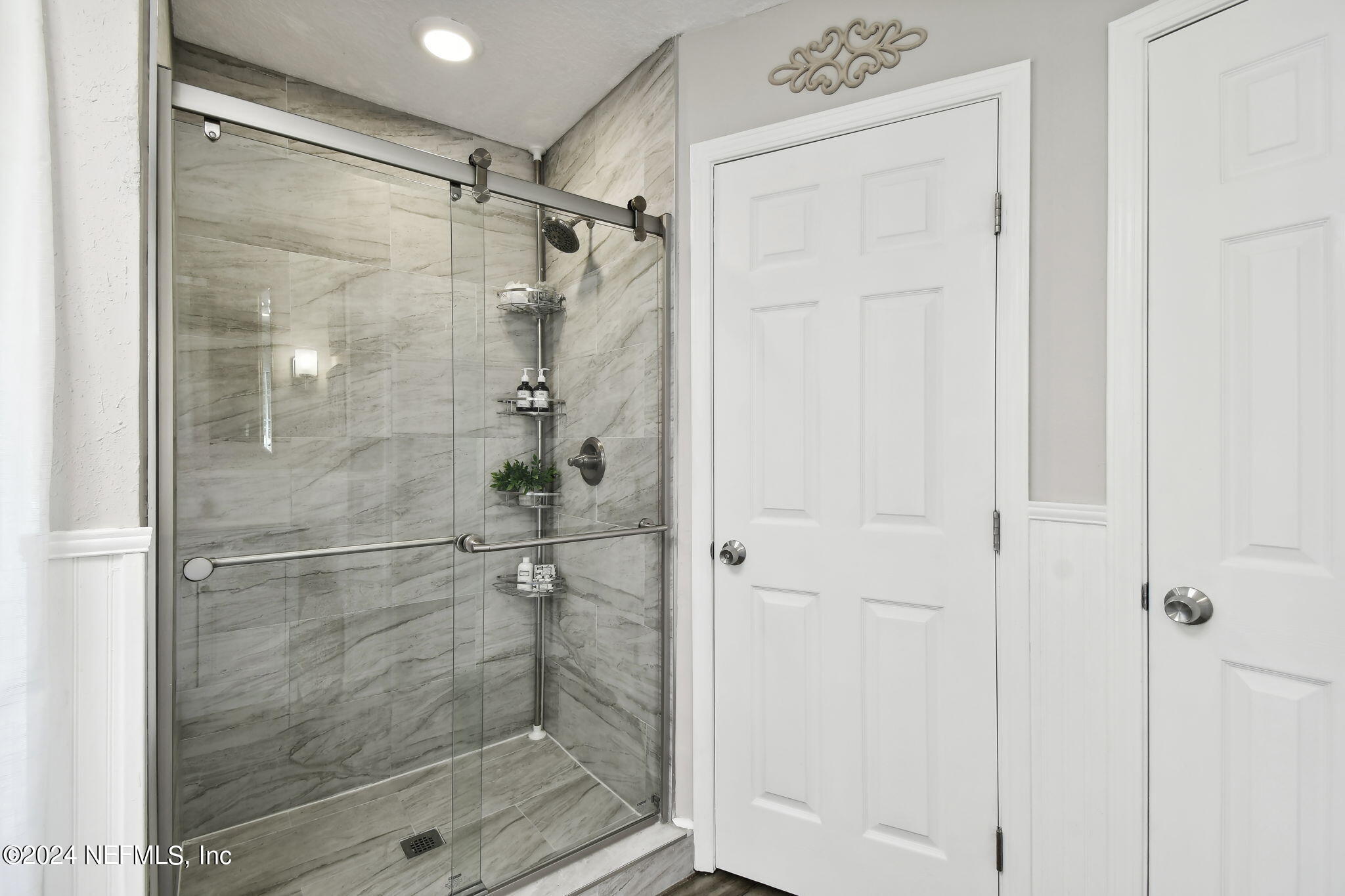 7473 Devondale Way Jacksonville, FL 32256 - Photo 39 of 68 a bathroom with a glass shower door