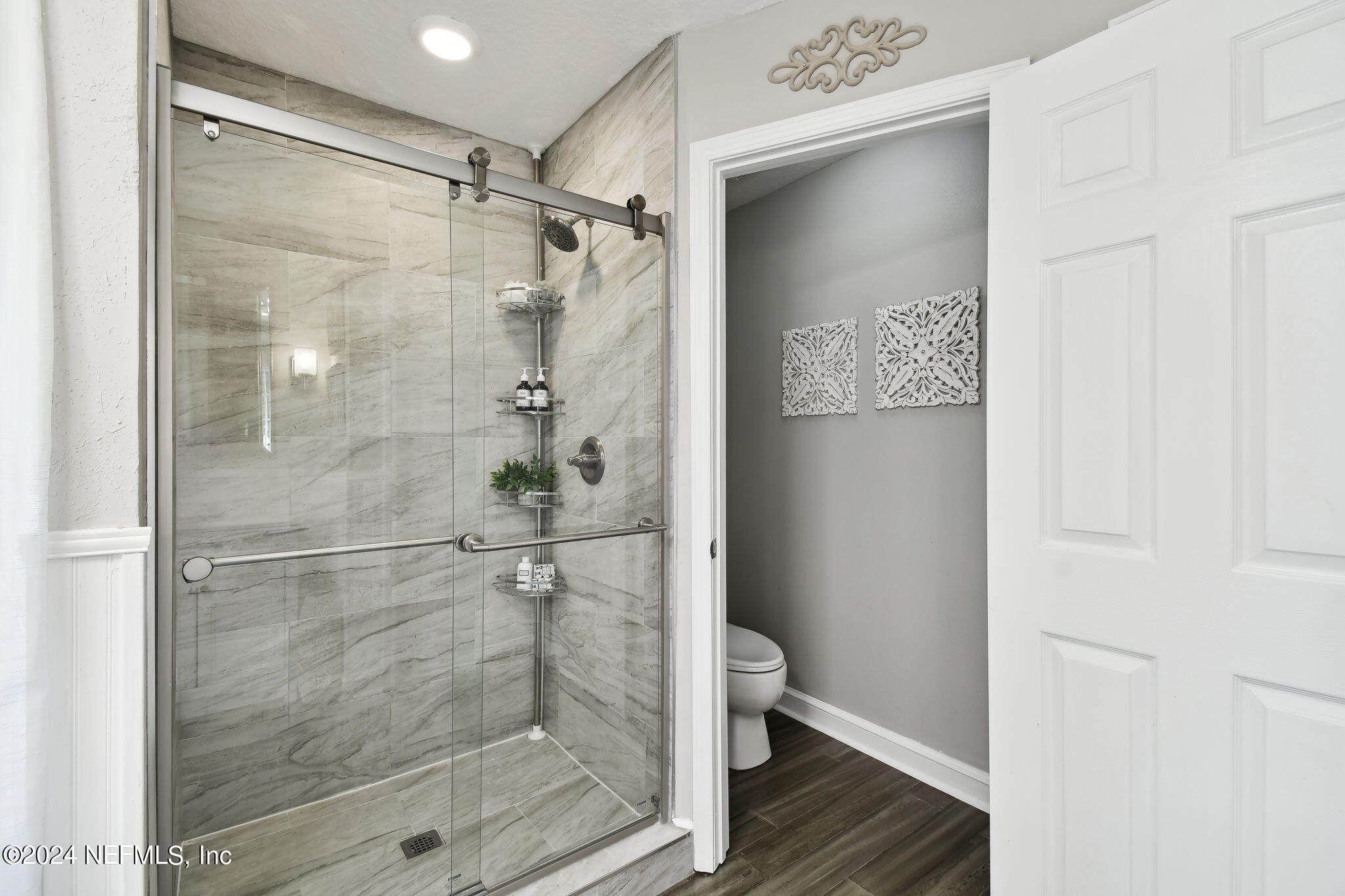 7473 Devondale Way Jacksonville, FL 32256 - Photo 40 of 68 a bathroom with a glass shower door