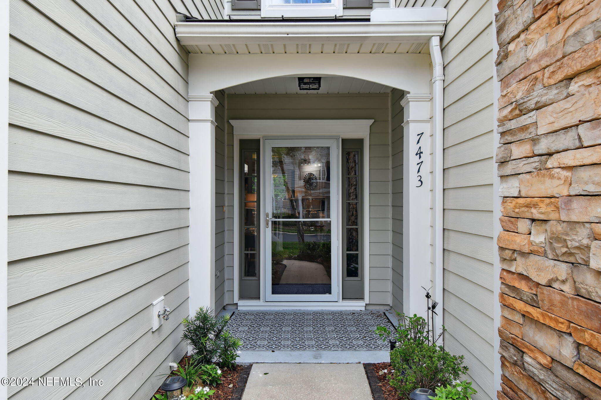 7473 Devondale Way Jacksonville, FL 32256 - Photo 4 of 68 a front view of a house with a garden