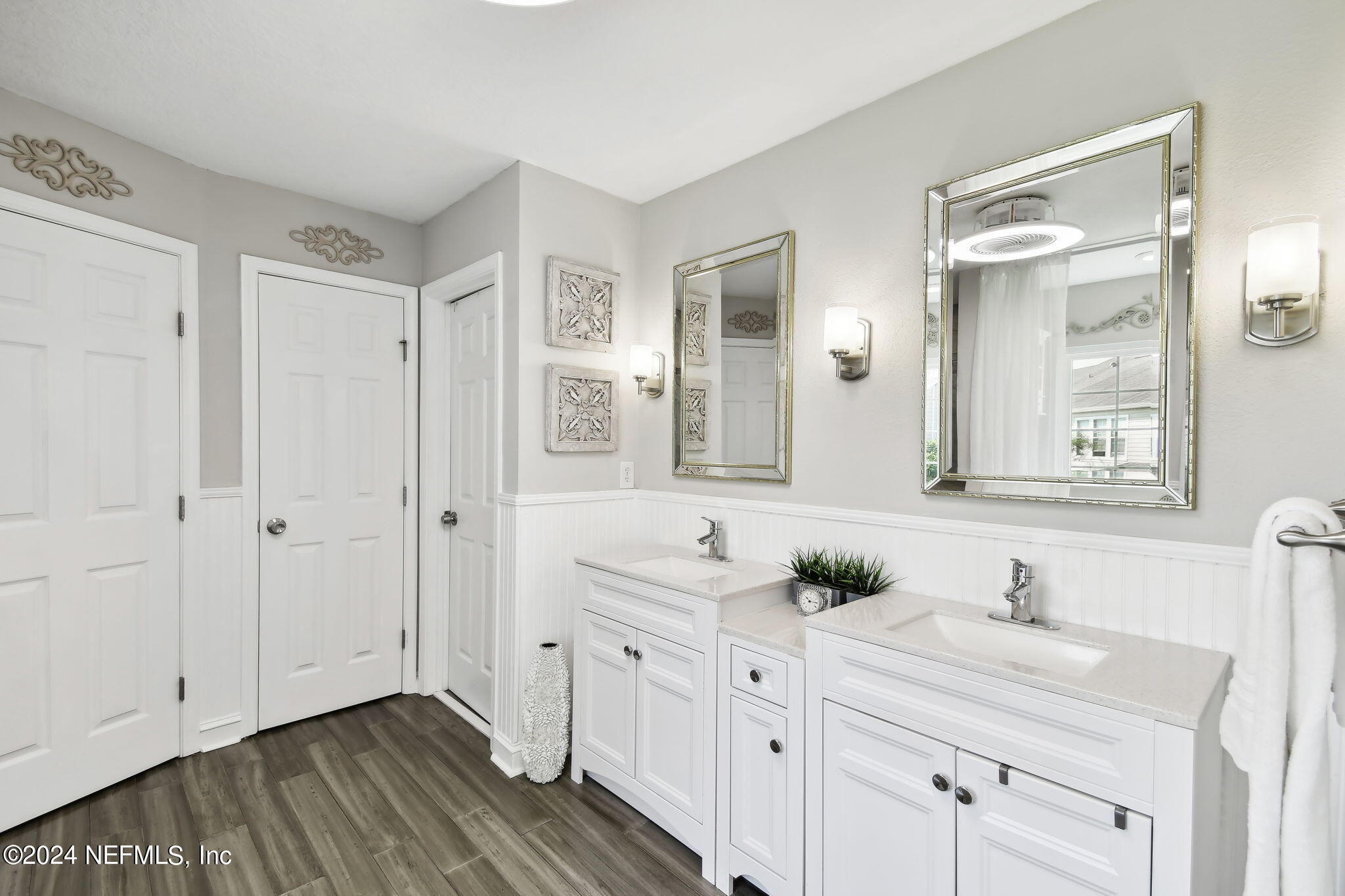 7473 Devondale Way Jacksonville, FL 32256 - Photo 42 of 68 a bathroom with a double vanity sink and mirror