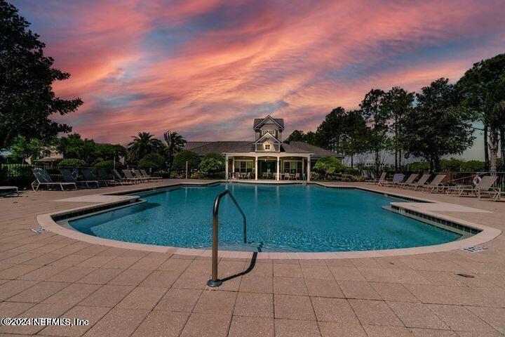 7473 Devondale Way Jacksonville, FL 32256 - Photo 60 of 68 a view of a swimming pool with a yard