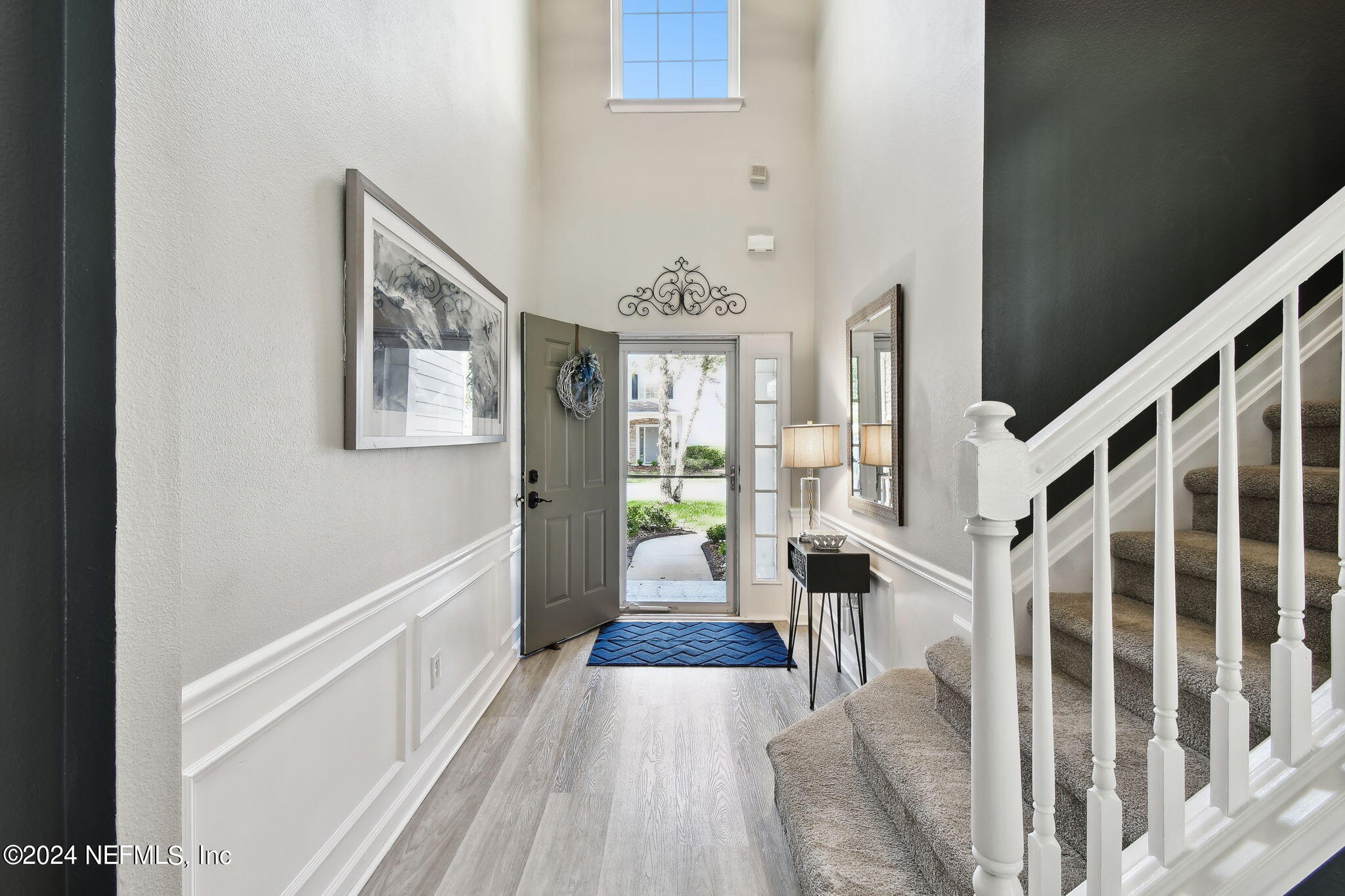 7473 Devondale Way Jacksonville, FL 32256 - Photo 6 of 68 a view of a hallway with wooden floor and staircase
