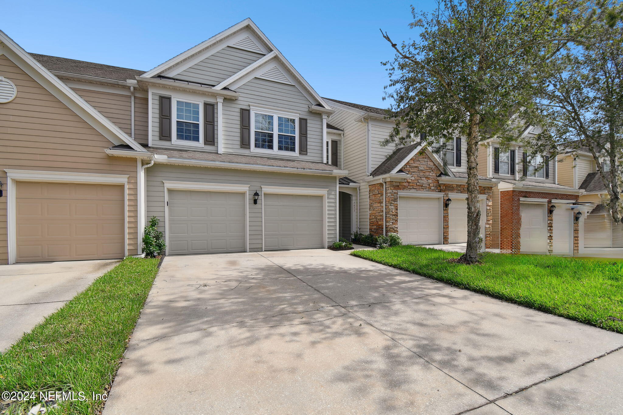 7473 Devondale Way Jacksonville, FL 32256 - Photo 66 of 68 a front view of a house with a yard and garage