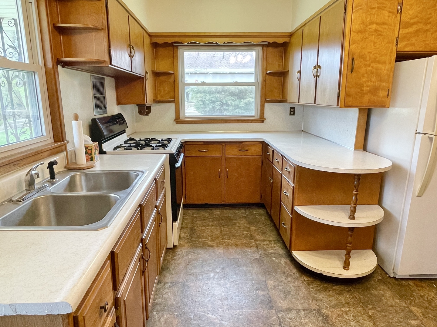 505 North St Paul Street Mark, IL 61326 - Photo 16 of 24 a kitchen with a sink and a stove next to a window