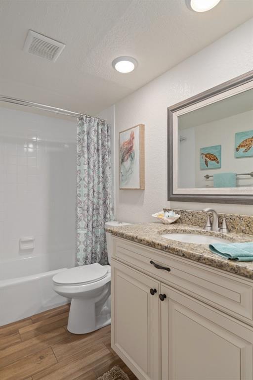 8211 Brent Street, Unit 847 Port Richey, FL 34668 - Photo 18 of 29 a bathroom with a granite countertop sink toilet and painting on the wall