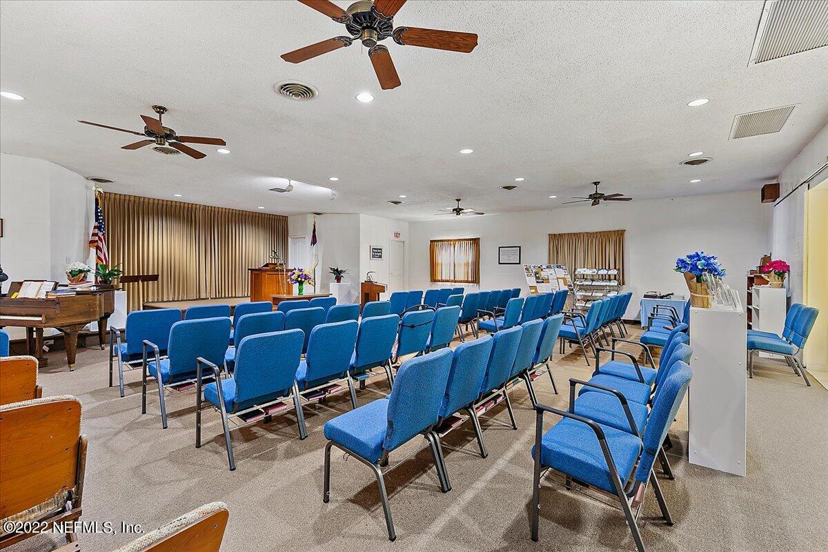 2701 Dean Road Jacksonville, FL 32216 - Photo 5 of 19 a living room with lots of furniture and a chandelier