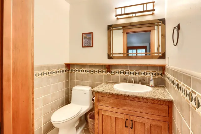 a bathroom with a toilet sink and mirror