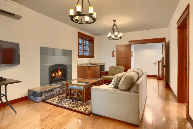a living room with furniture a fireplace and a flat screen tv
