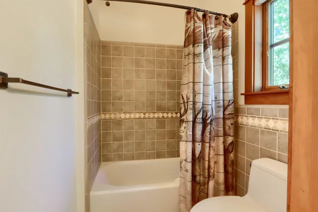 a bedroom with two beds and a chandelier