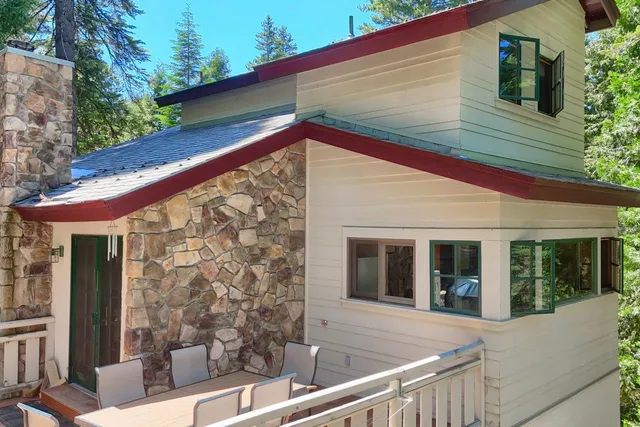 a view of a patio with dining table and chairs with wooden floor and fence