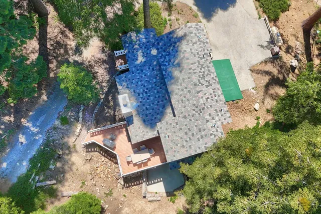 an aerial view of a house with yard