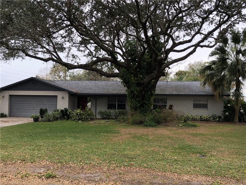 a front view of house with yard and green space