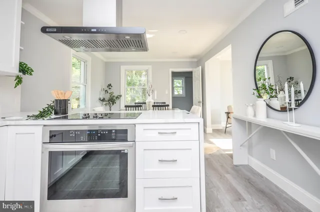 a kitchen with a stove and a white cabinets