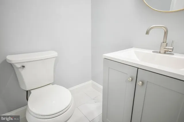 a white toilet sitting next to a bathroom sink
