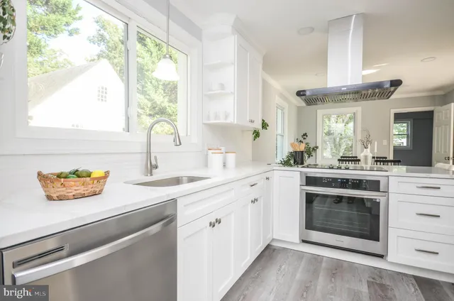 a kitchen with a sink stove and cabinets