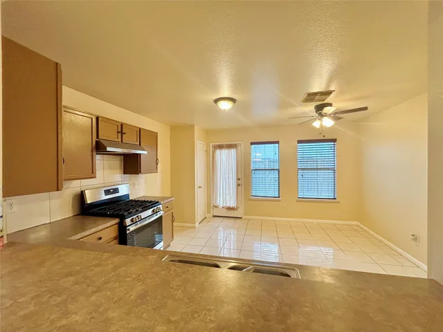 a view of a kitchen with a sink and cabinets