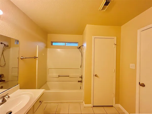 a bathroom with a bathtub and shower