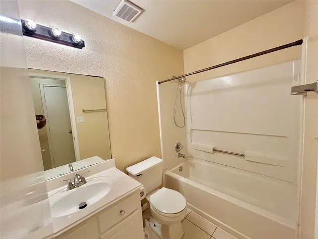 a bathroom with a sink mirror vanity and toilet