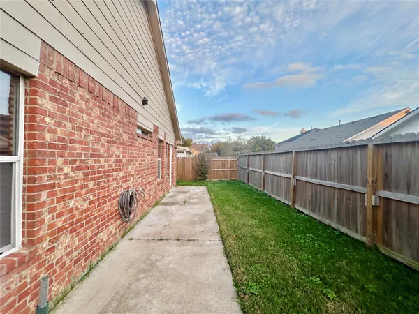 a view of a backyard with wooden fence