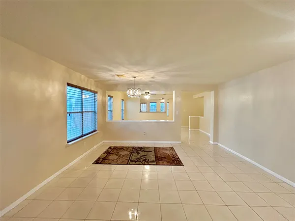 a view of a livingroom with wooden floor and a window